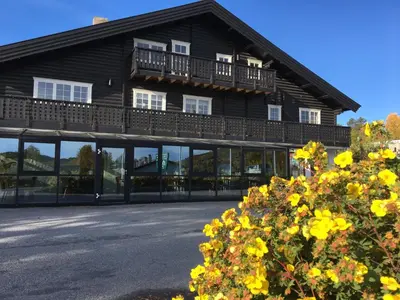 a large building with windows and a balcony at Øen Turistsenter Apartments in Geilo
