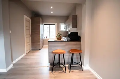 a kitchen with two stools in front of a counter at Trolltunga Living in Tysso