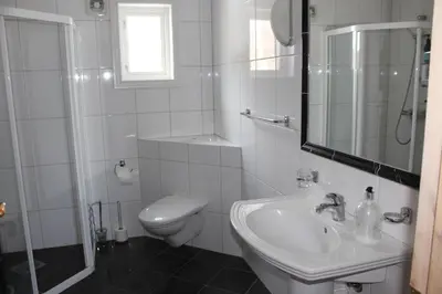 a white bathroom with a toilet and a sink at Magnesplass - Dagalifjell in Dagali