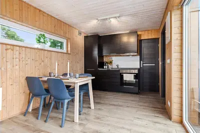a kitchen and dining room with a table and chairs at Topcamp Onsakervika - Tyrifjorden in Svensrud