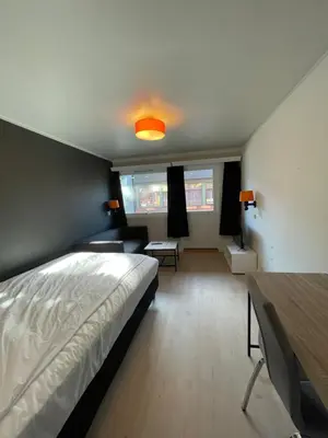 a bedroom with a bed and a table in it at Namsen Hotell in Namsos