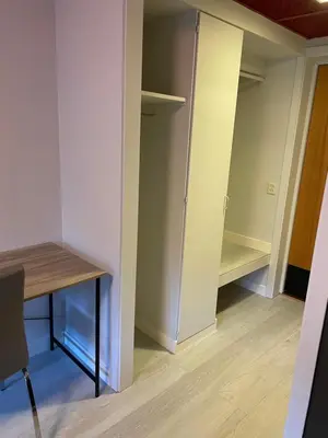a room with a desk and a closet at Namsen Hotell in Namsos