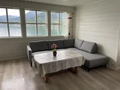 a living room with a couch and a table at Fjord Apartments in Dimmelsvik