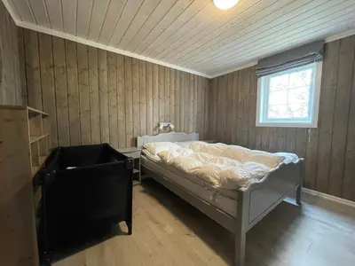 a bedroom with a bed in a room with a window at Sigurdhytta in Ål