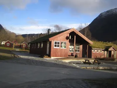 a small wooden building with a bench in front of it at Seim Camping - Røldal in Røldal