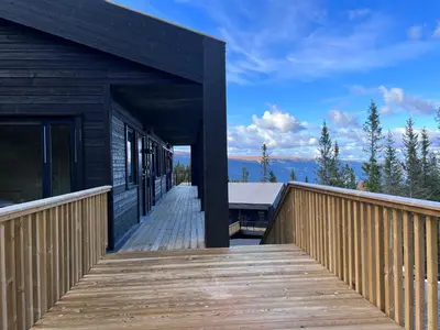 a wooden walkway leading up to a building with a deck at Gausta View in Gaustablikk