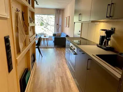 a kitchen with white cabinets and a table in a room at Gausta View in Gaustablikk