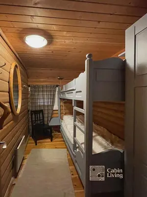 a bunk bed in a room with wooden walls at Cozy cottage in central Beitostølen with Sauna in Beitostøl