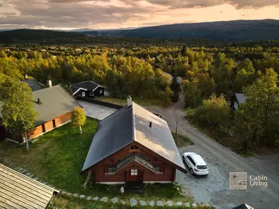an aerial view of a house with a car parked next to it at Cozy cottage in central Beitostølen with Sauna in Beitostøl