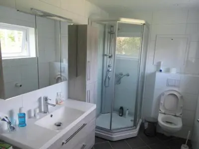 a bathroom with a shower and a sink and a toilet at Airbnb and Booking at Postvegen 95 in Vigra