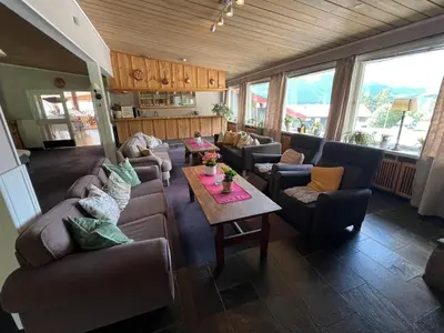 a living room with couches and a table at Hallingskarvet Fjellstue as in Hovet