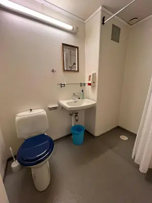 a bathroom with a toilet and a sink at Hallingskarvet Fjellstue as in Hovet