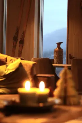 a living room with candles in front of a window at Cozy Apartment by the slopes in Kvitfjell Vest in Favang