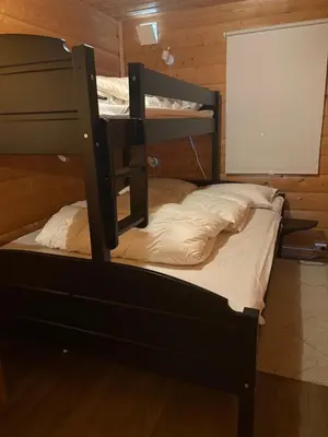 a bunk bed in a wooden room with a screen at Uvdalhytta - close to cross country and downhill skiing in Uvdal