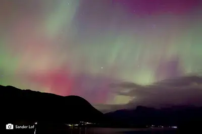 an aurora in the sky over a mountain at Seaside 3-bedroom House in Svelgen