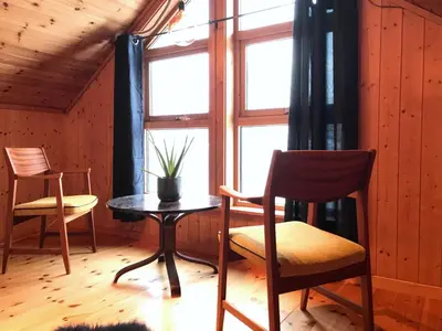 a room with a table and chairs and a window at Seaside 3-bedroom House in Svelgen