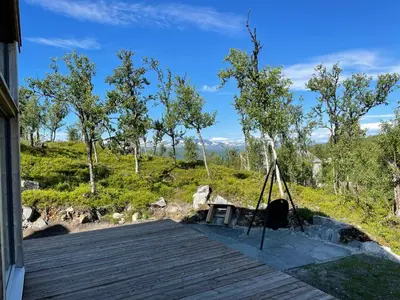a wooden deck with a tripod on top of it at Skarvhytta - moderne hytte med flott beliggenhet in Hol