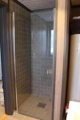 a shower with a glass door in a bathroom at Skarvhytta - moderne hytte med flott beliggenhet in Hol