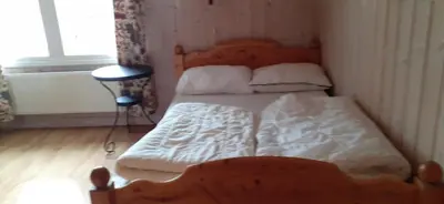 a bedroom with a bed with a wooden head board at Beitostølen Hytter in Beitostøl