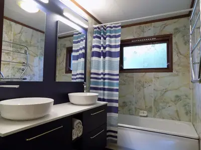 a bathroom with two sinks and a shower at Kråkehaugen Feriehus, a perfect holiday retreat near Åheim in Åheim