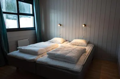 a bed in a room with two pillows on it at Bakkebyvegen 22B in Trysil