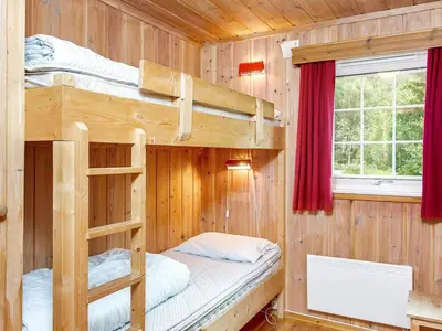 a bedroom with two bunk beds in a cabin at 7 person holiday home in Hemsedal-By Traum in Hemsedal
