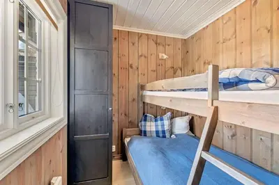 a room with two bunk beds and a window at Gaustablikk hytta ski-in ski-out in Gaustablikk