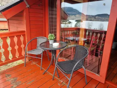 a table and chairs on the porch of a house at Kvamshaugen hytter in Luster