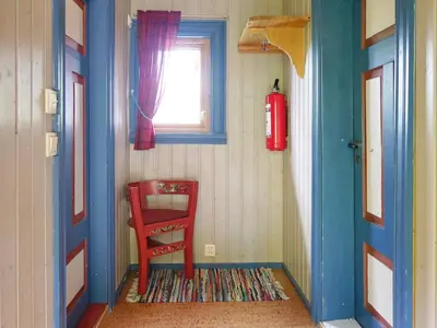 a red chair sitting in a room with a window at 5 person holiday home in Hemsedal-By Traum in Hemsedal