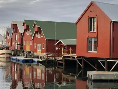 a row of houses next to a body of water at Robinsons Rorbu - located in Bud in Bud