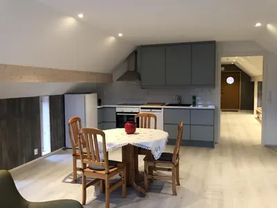 a kitchen with a table and chairs in a room at Robinsons Rorbu - located in Bud in Bud
