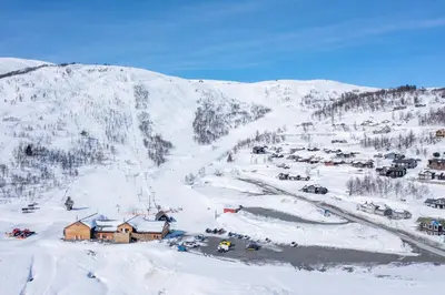 a ski resort in the snow with a mountain at Ski in ski out mountain cabin with views and extra unit option in Sogndal