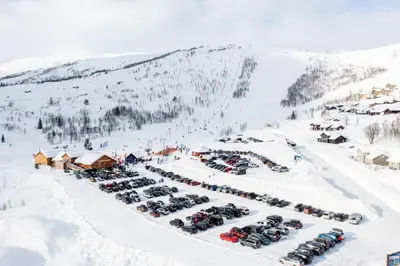 an aerial view of a parking lot in the snow at Ski in ski out mountain cabin with views and extra unit option in Sogndal