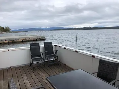 two chairs sitting on the deck of a boat at Kviltorp Camping in Molde