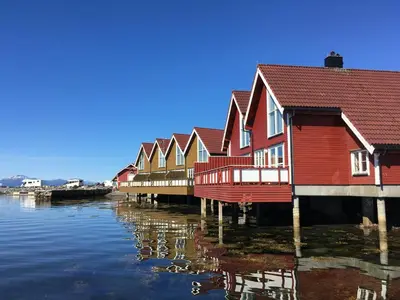 a row of houses sitting on the water at Kviltorp Camping in Molde