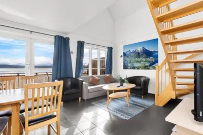 a living room with a couch and a table at Kviltorp Camping in Molde