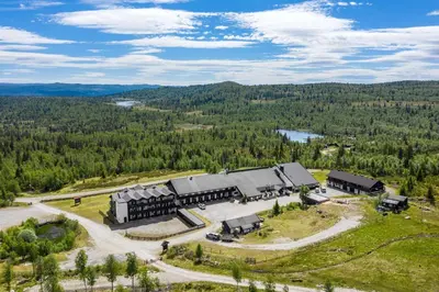 an aerial view of a building in the woods at Ranten Hotell Best Western Signature Collection in Nesbyen