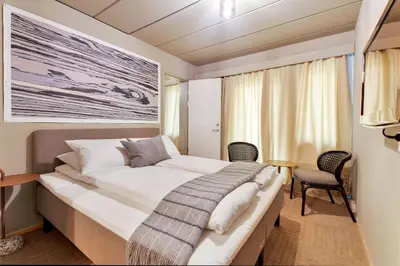 a bedroom with a large bed in a room at Ranten Hotell Best Western Signature Collection in Nesbyen