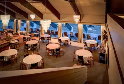 a restaurant with tables and chairs and a large window at Ranten Hotell Best Western Signature Collection in Nesbyen