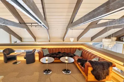 a room with a couch and two tables at Ranten Hotell Best Western Signature Collection in Nesbyen