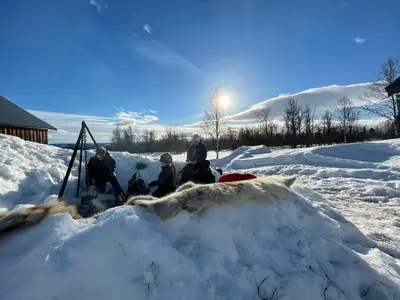 a group of people sitting in a pile of snow at Olebu in Skammestein