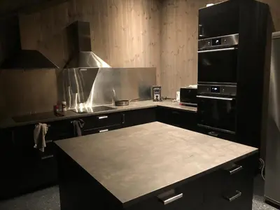 a kitchen with a stove and a counter top at Hytte på Myhre Gård in Skammestein