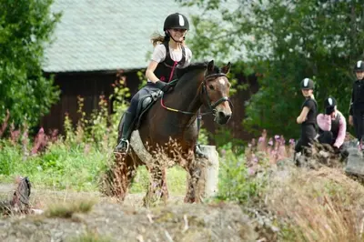 a young girl riding a horse in a field at Hytte på Myhre Gård in Skammestein