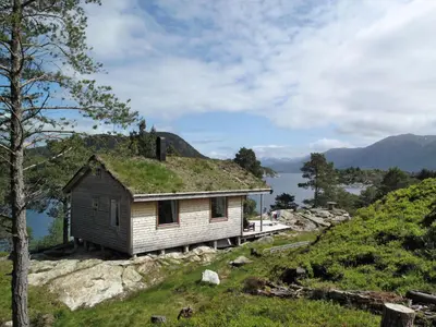 an old house with grass on the roof on a hill at Chalet Svanöy by Interhome in Grimeli