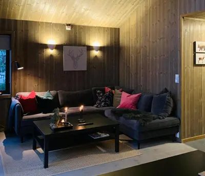 a living room with a couch and a coffee table at Cozy Apartment electric car charger & ski in out Sjusjøen in Sjusjøen