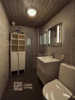a bathroom with a white toilet and a sink at Cozy Apartment electric car charger & ski in out Sjusjøen in Sjusjøen