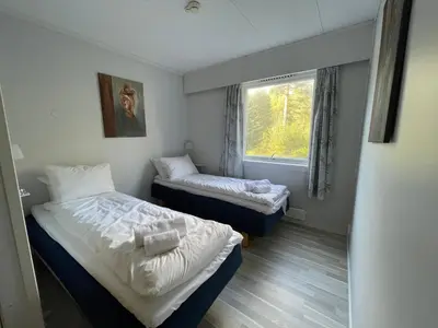a small room with two beds and a window at Fossanåsen Hotel in Flesberg