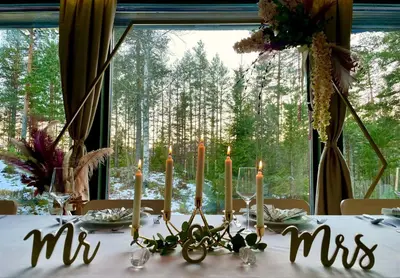 a table with candles on a table with a window at Fossanåsen Hotel in Flesberg