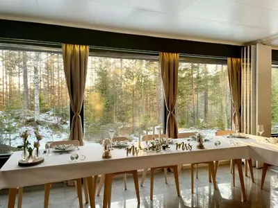 a dining room with a table and a large window at Fossanåsen Hotel in Flesberg
