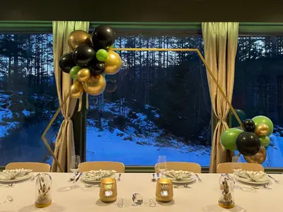 a table with balloons in a room with a window at Fossanåsen Hotel in Flesberg